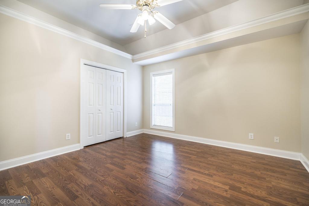 209 Trellis Walk Centerville, GA 31028 - Photo 31 of 38 a view of an empty room with wooden floor and a ceiling fan