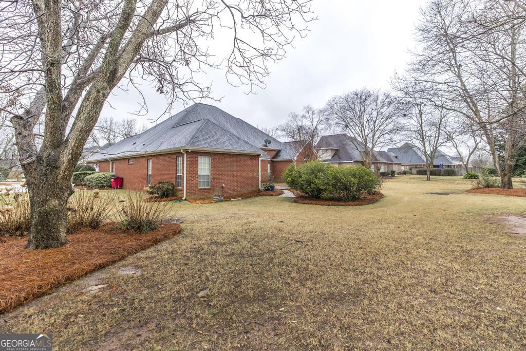 209 Trellis Walk Centerville, GA 31028 - Photo 35 of 38 a front view of a house with a yard and garage