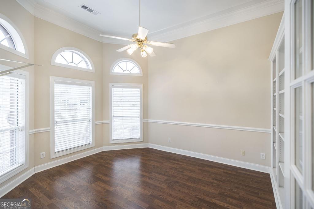 209 Trellis Walk Centerville, GA 31028 - Photo 8 of 38 an empty room with wooden floor fan and windows