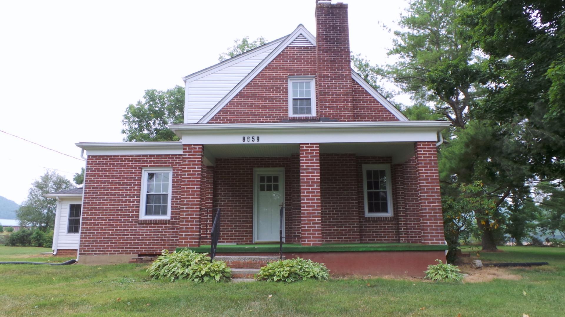 8659 Roanoke Road Elliston, VA 24087 - Photo 1 of 32 a front view of a house with a yard