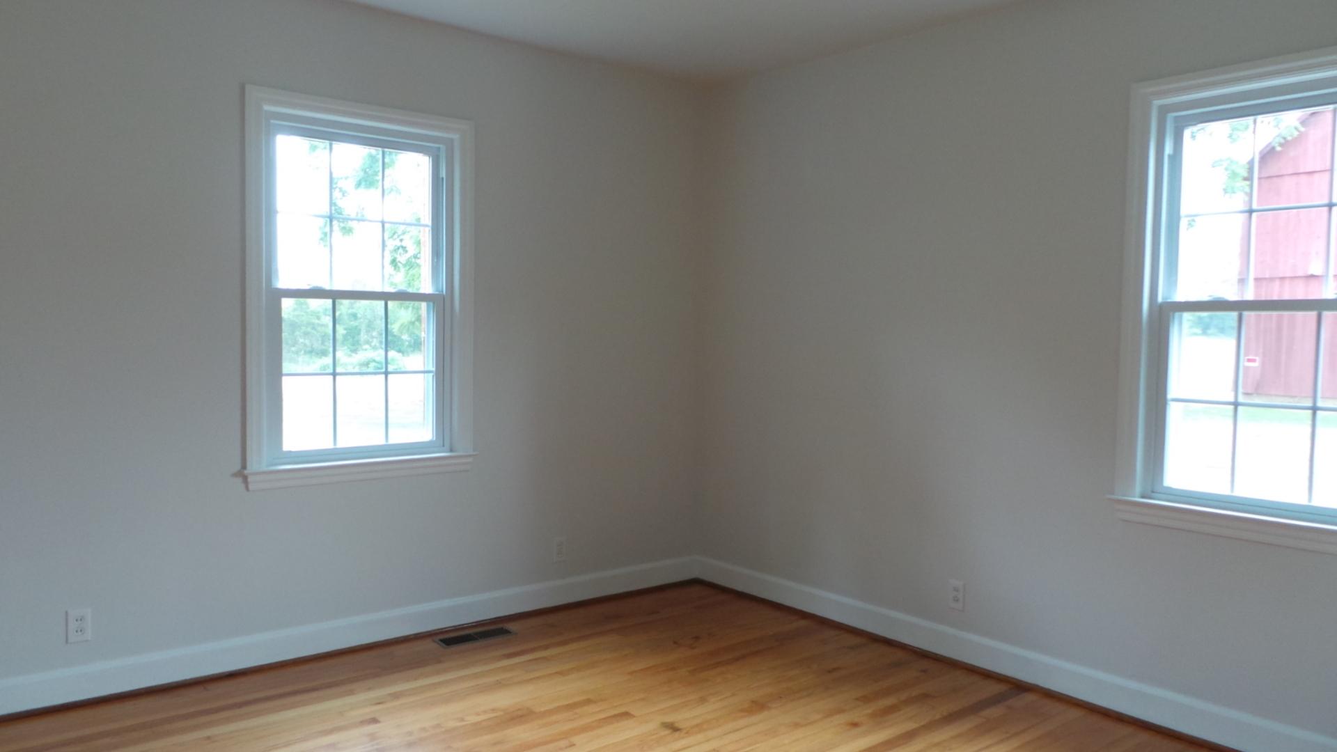 8659 Roanoke Road Elliston, VA 24087 - Photo 15 of 32 an empty room with wooden floor and windows