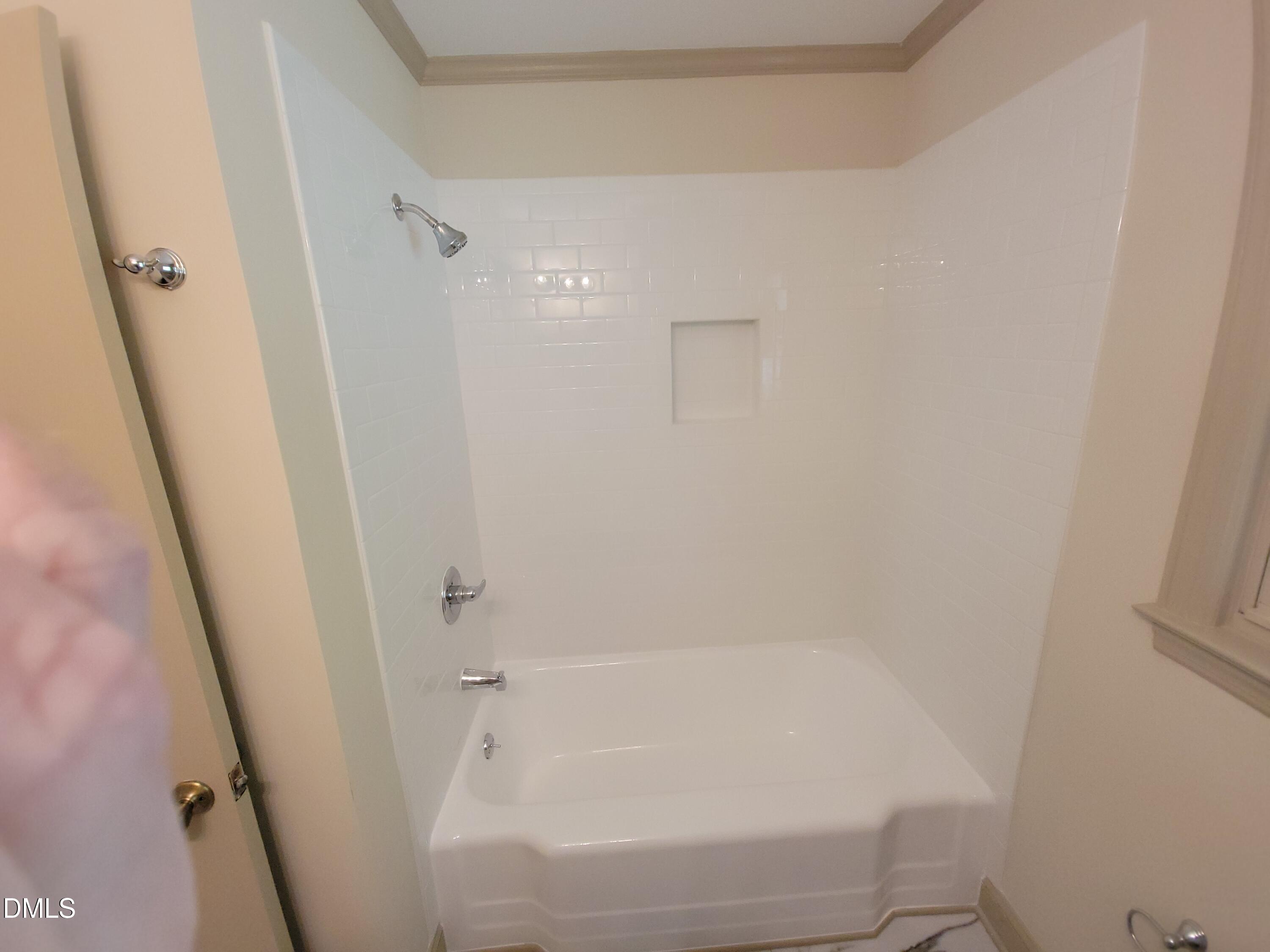 7000 Holly Springs Road Raleigh, NC 27606 - Photo 21 of 24 a bathroom with a bathtub