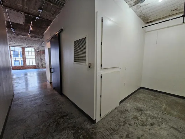 a view of hallway with stairs and wooden floor