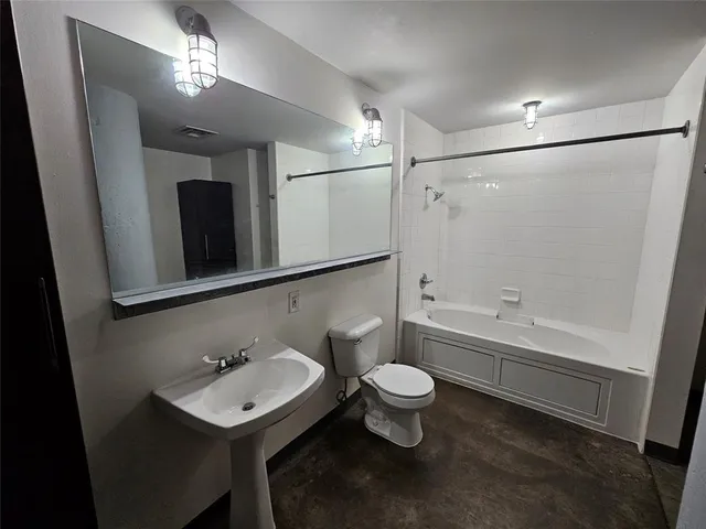 a bathroom with a sink mirror toilet and bathtub