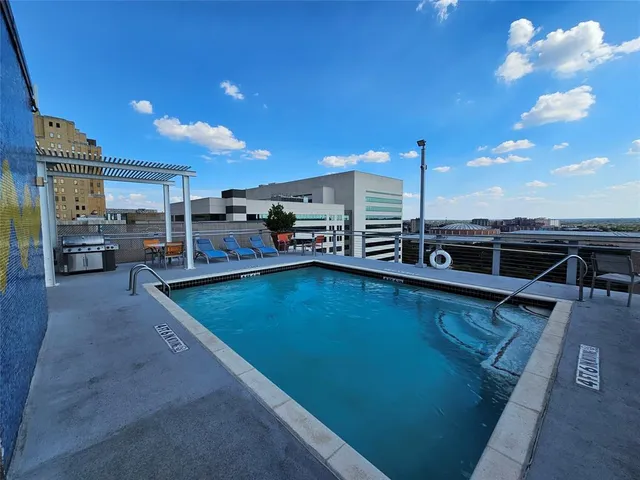 a view of a swimming pool with chairs