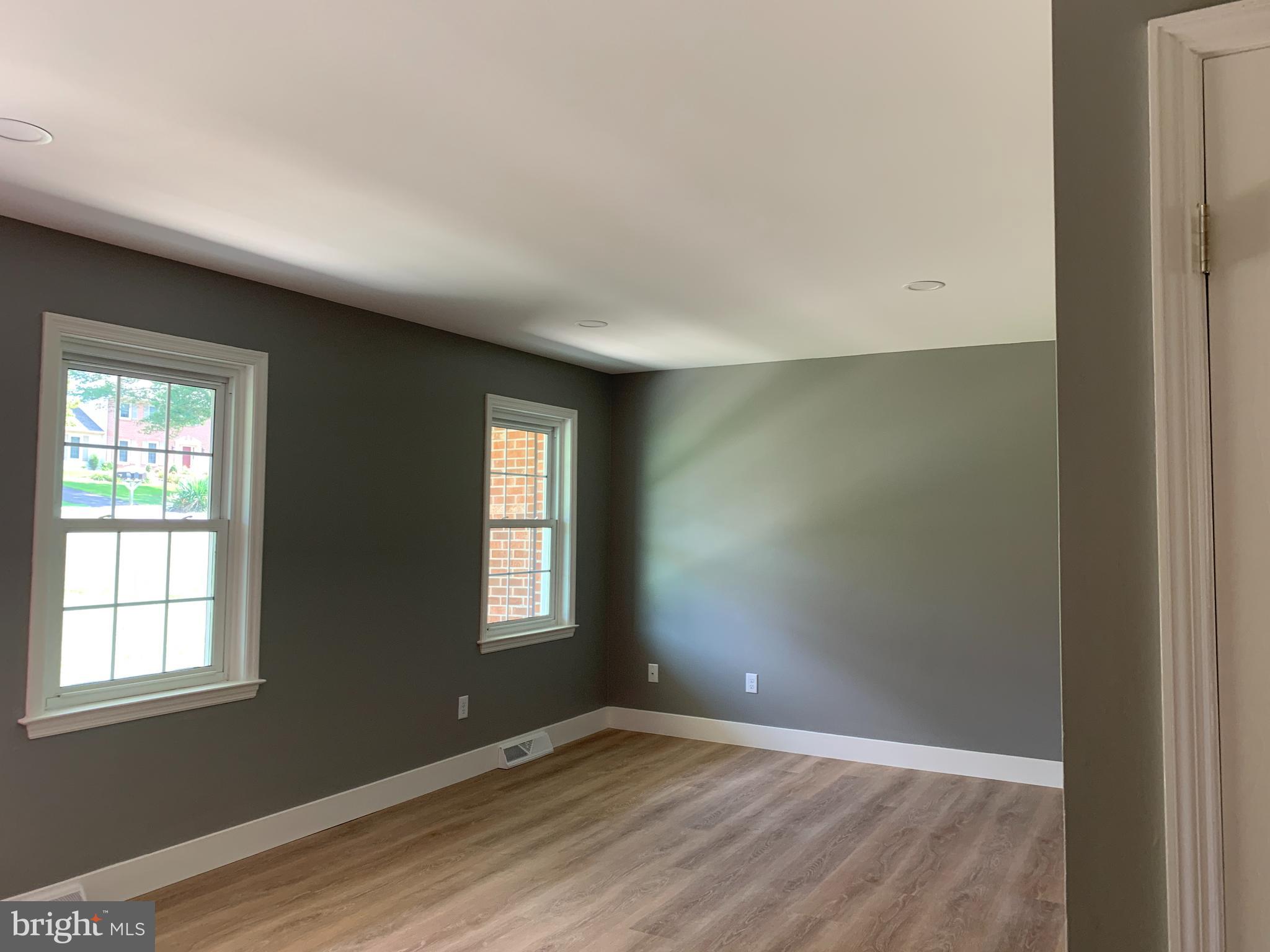 549 Hi View Drive Lititz, PA 17543 - Photo 5 of 42 an empty room with wooden floor and windows