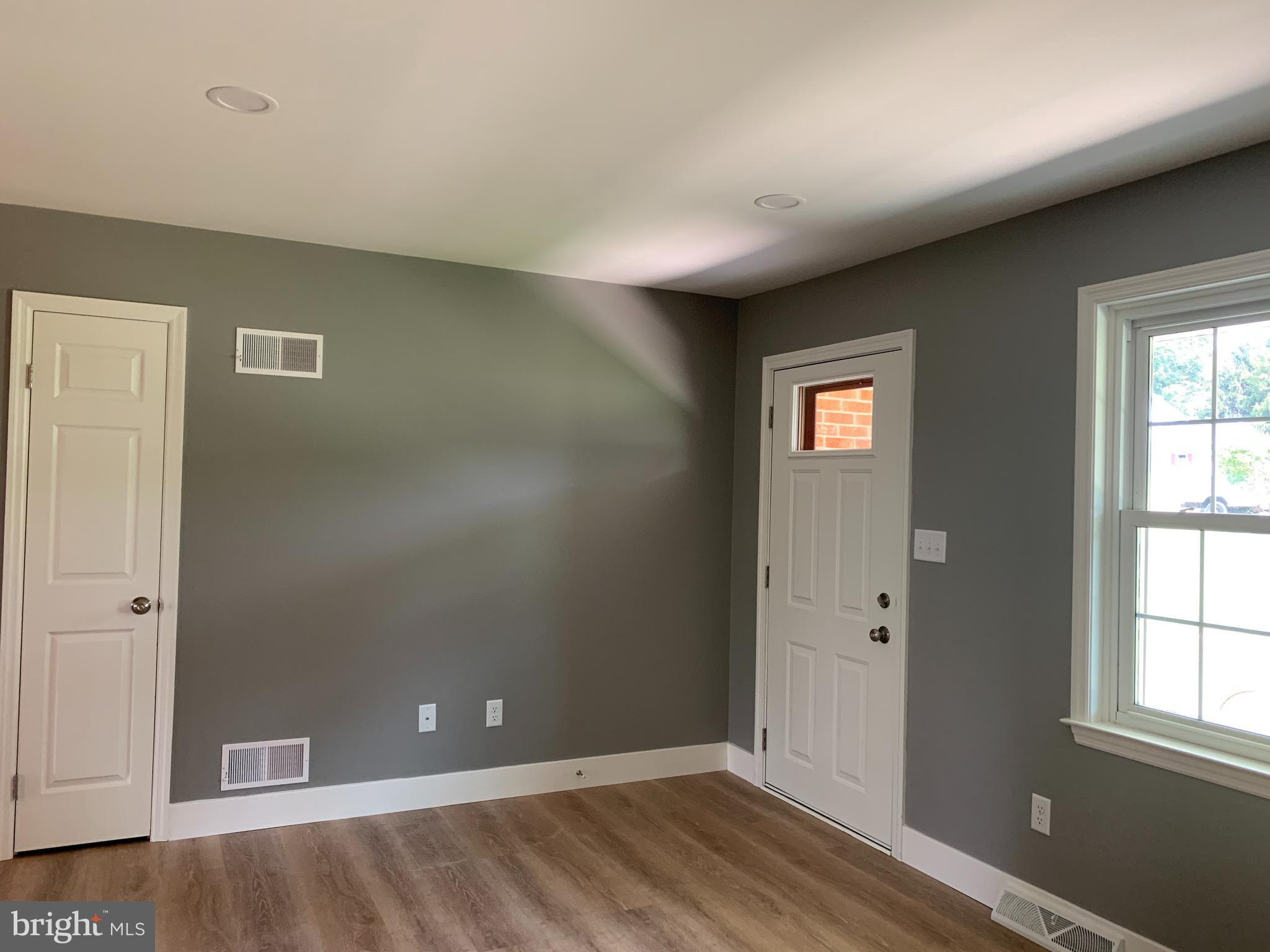 549 Hi View Drive Lititz, PA 17543 - Photo 6 of 42 an empty room with wooden floor and windows