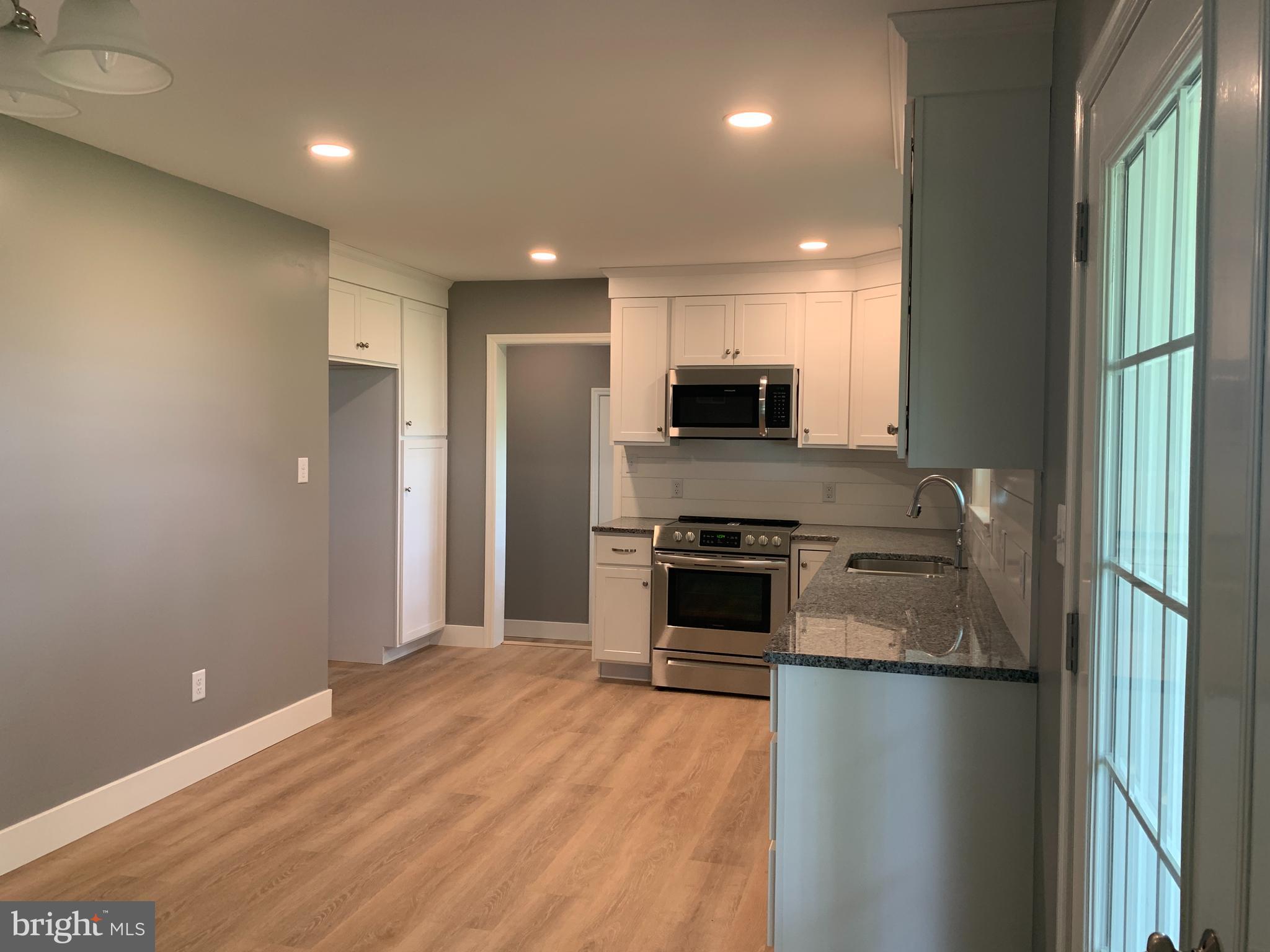 549 Hi View Drive Lititz, PA 17543 - Photo 9 of 42 a kitchen with kitchen island a counter top space stainless steel appliances and cabinets