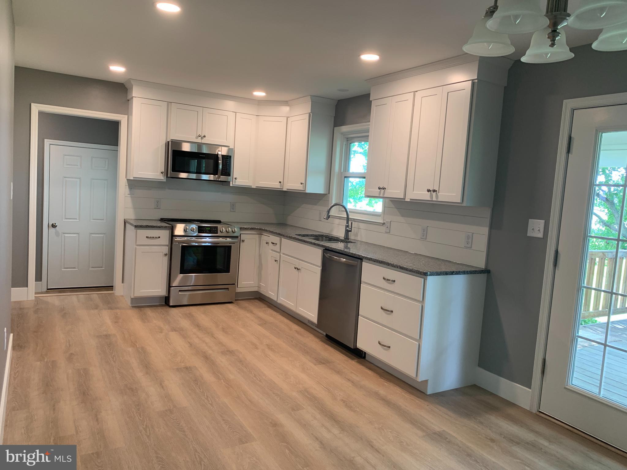 549 Hi View Drive Lititz, PA 17543 - Photo 10 of 42 a kitchen with stainless steel appliances granite countertop a stove a sink and a microwave