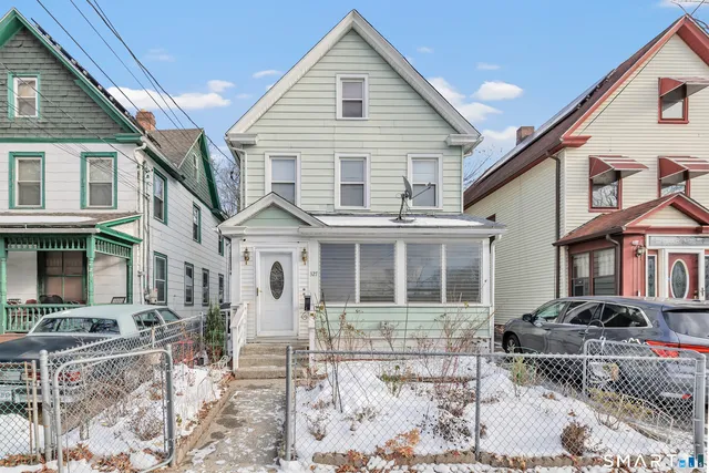 a view of a white house with large windows