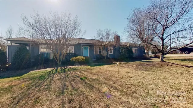 a view of a house with a yard covered in snow