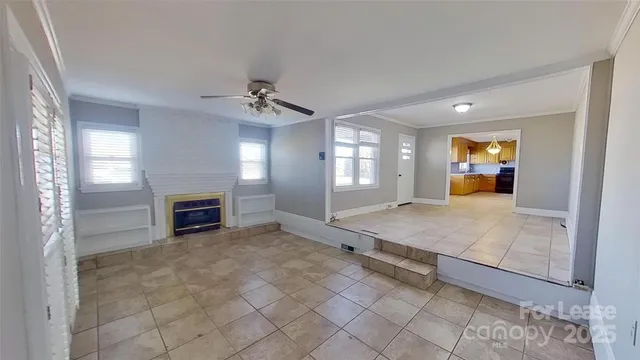 a view of a livingroom with a fireplace and window
