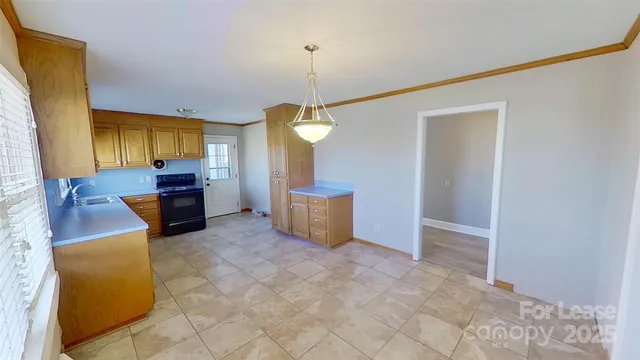 a view of a kitchen with a sink and cabinets