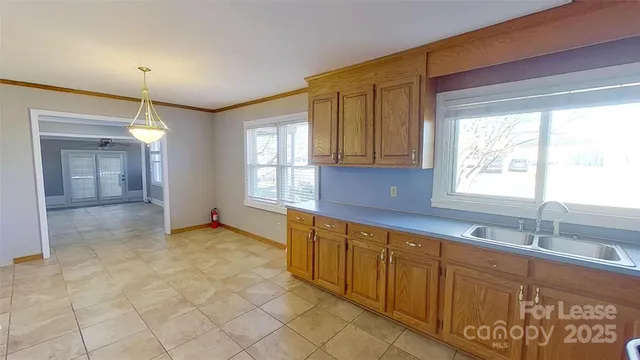 a view of a kitchen with a sink and windows