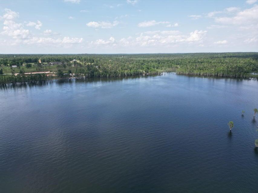 Lot 17 Dorcas Road Marianna, FL 32448 - Photo 18 of 18 a view of a lake with houses in the background