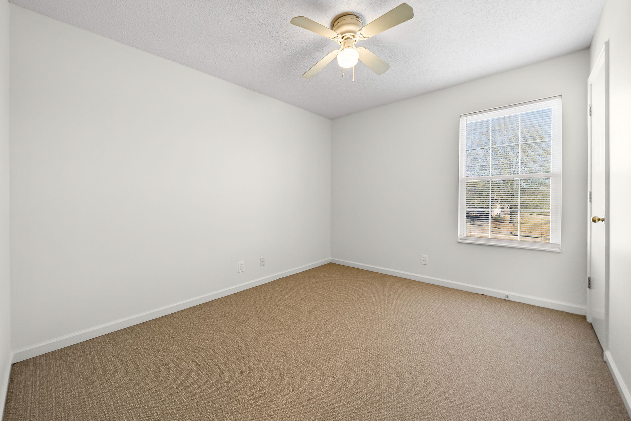 3300 Royster Lane, Unit C Clarksville, TN 37042 - Photo 15 of 18 an empty room with a window and a fan