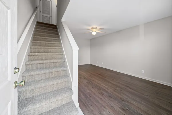 a view of entryway and hall with wooden floor