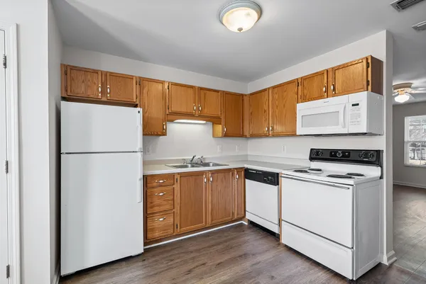 a kitchen with stainless steel appliances granite countertop a refrigerator a stove a sink and a microwave