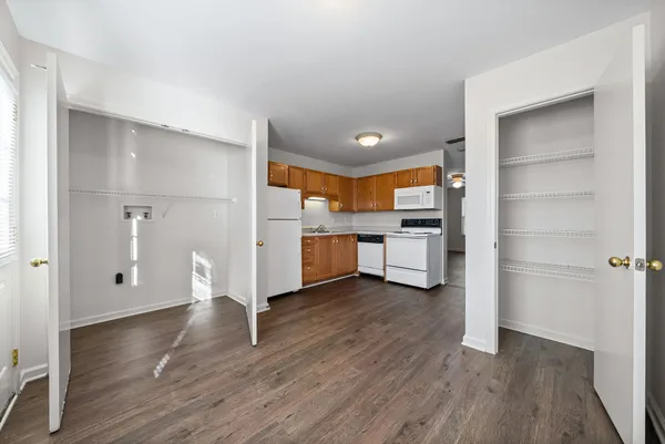 a view of a kitchen with wooden floor and electronic appliances
