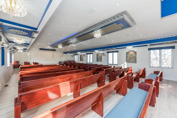 a room with lots of wooden furniture and a large window
