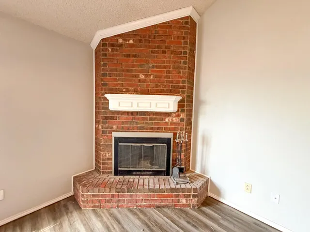 a view of fireplace and wooden floor