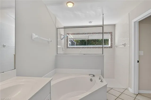 a bathroom with a bathtub and a shower