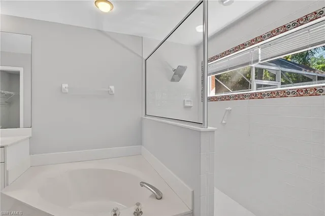 a bathroom with a tub and shower