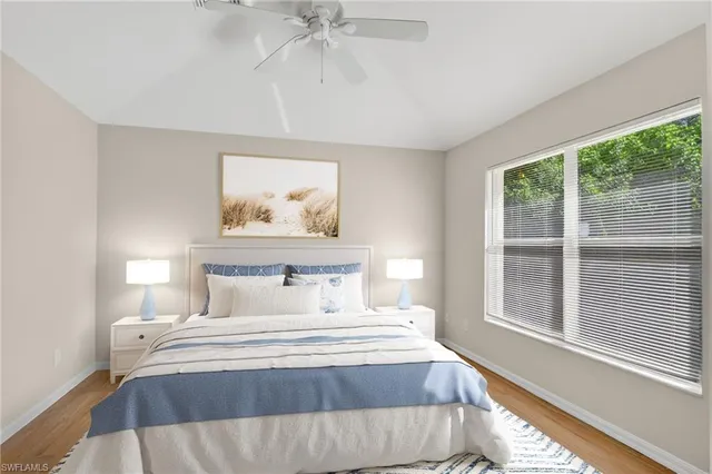 a bedroom with a large bed and a window