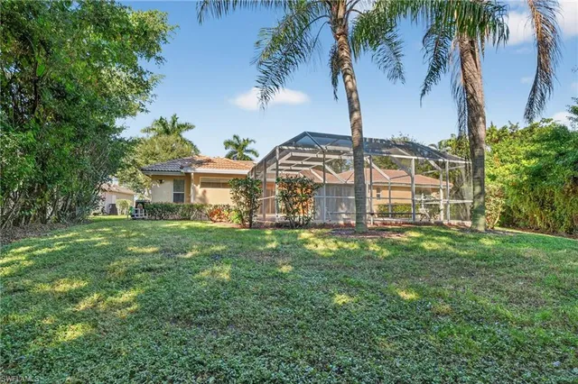 a view of a house with a backyard