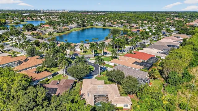 an aerial view of residential houses with outdoor space and river