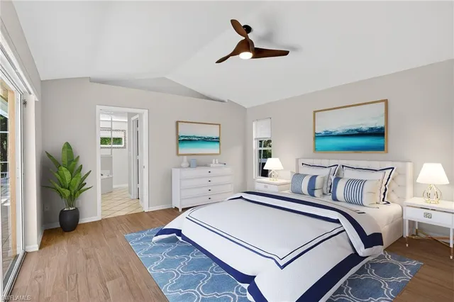 a bedroom with a bed and a potted plant