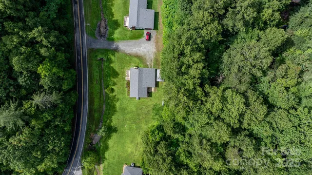 an aerial view of a house with a yard