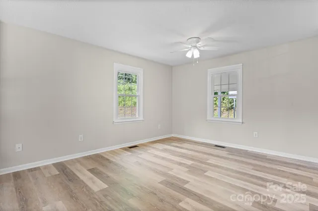 wooden floor in an empty room with a window