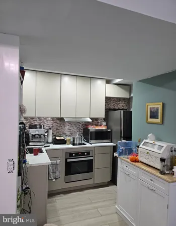 a kitchen with a stove and a refrigerator