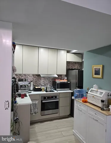 a kitchen with a stove and a refrigerator