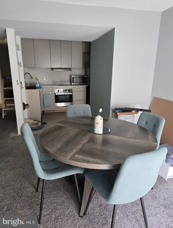 a kitchen with a table chairs and a refrigerator