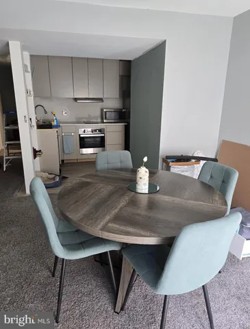 a kitchen with a table chairs and a refrigerator