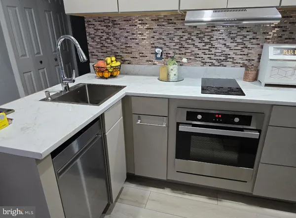 a kitchen with a stove and a sink