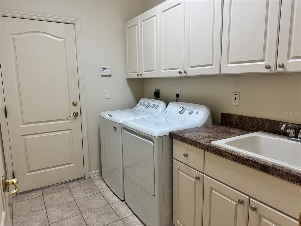 11145 Northwest 17th Court Road Ocala, FL 34475 - Photo 42 of 59 a utility room with granite countertop cabinets and sink
