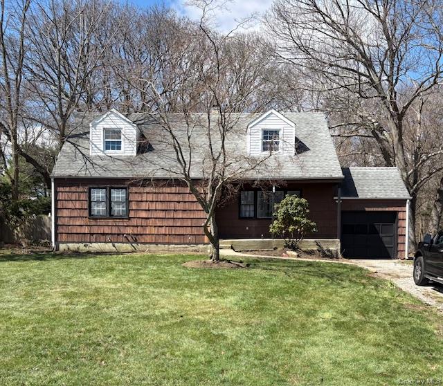 1134 Stony Brook Road Lake Grove, NY 11755 - Photo 1 of 18 a front view of a house with a yard