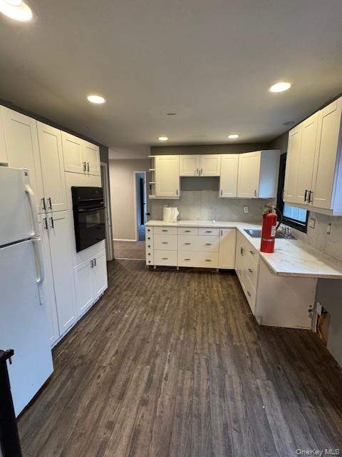 1134 Stony Brook Road Lake Grove, NY 11755 - Photo 2 of 18 a large kitchen with stainless steel appliances a large counter top a sink a refrigerator and white cabinets