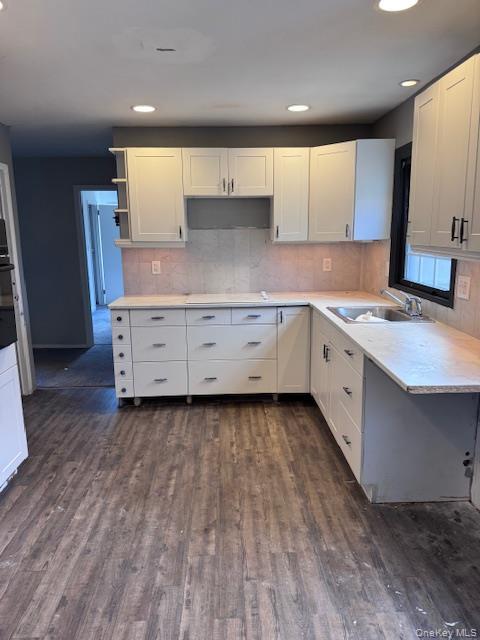 1134 Stony Brook Road Lake Grove, NY 11755 - Photo 3 of 18 a kitchen with a wooden floor and window