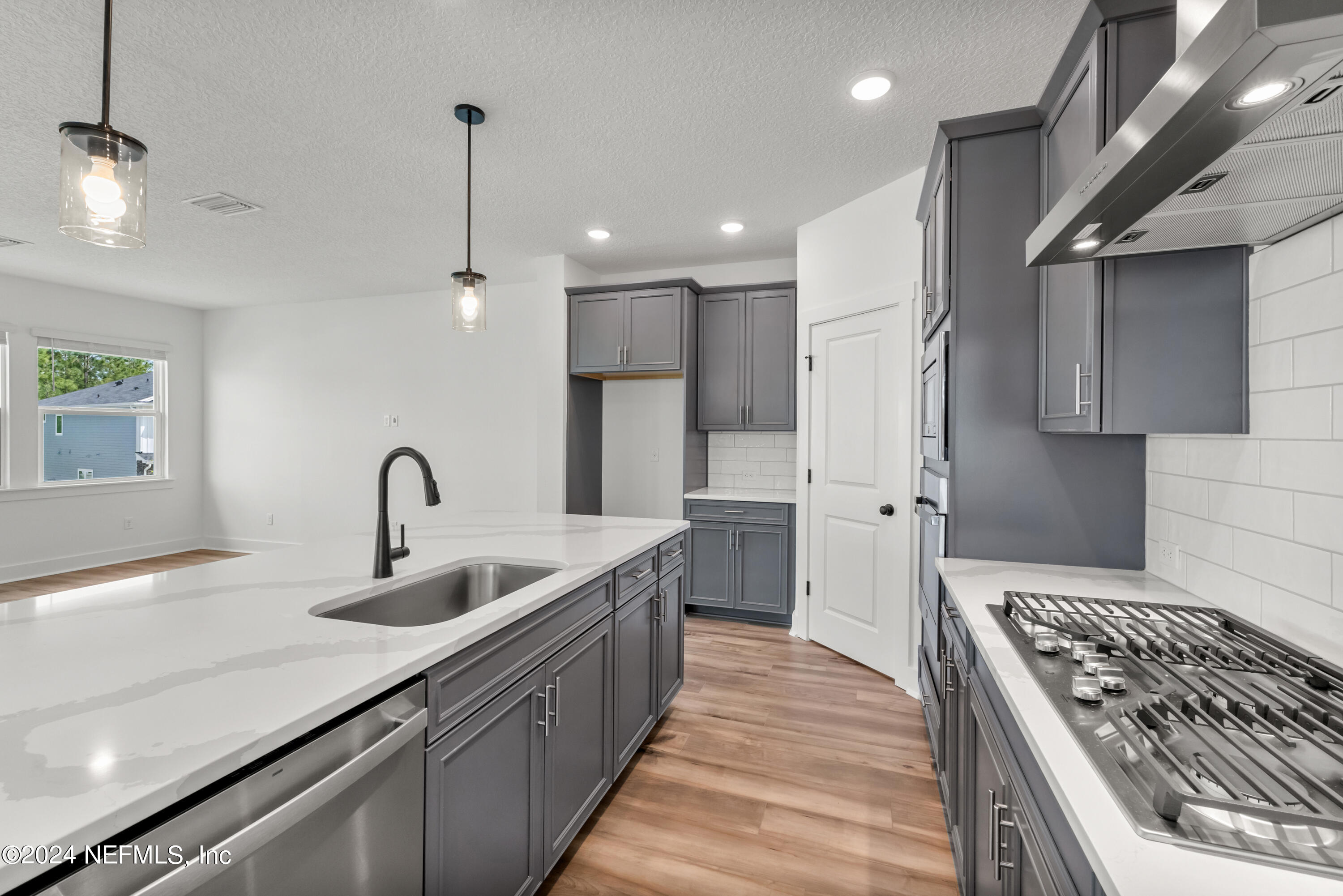 9830 Element Road Jacksonville, FL 32256 - Photo 6 of 18 a kitchen with stainless steel appliances granite countertop a sink stove and refrigerator