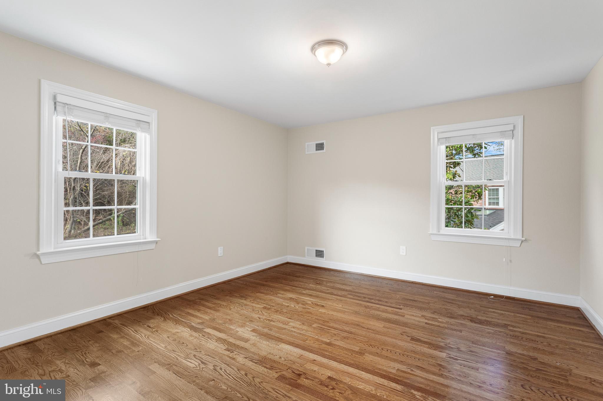 8403 Harker Drive Potomac, MD 20854 - Photo 11 of 33 an empty room with wooden floor and windows