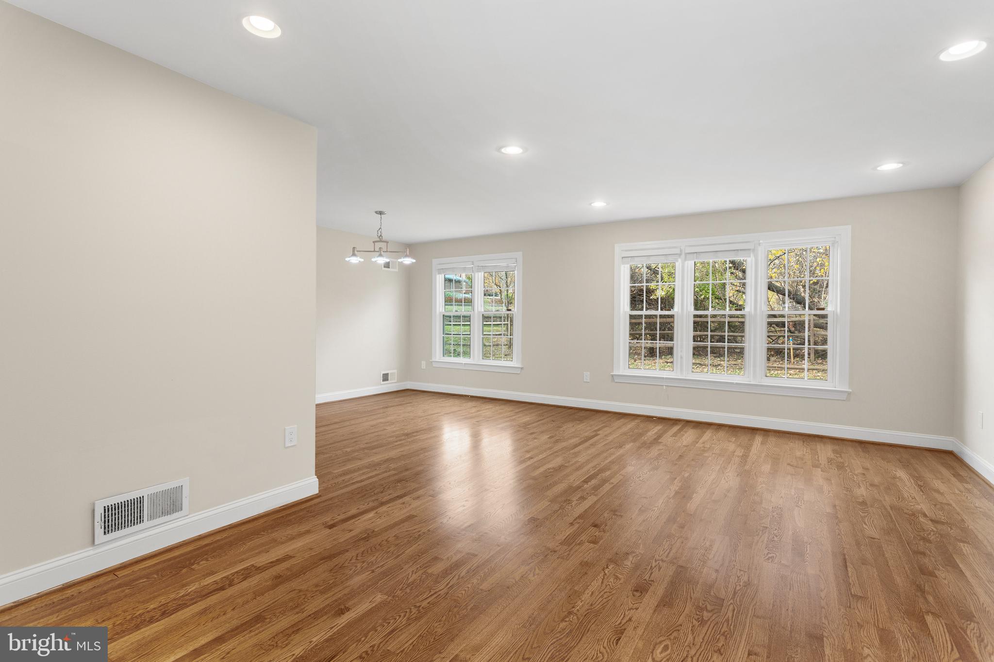 8403 Harker Drive Potomac, MD 20854 - Photo 2 of 33 an empty room with wooden floor and windows