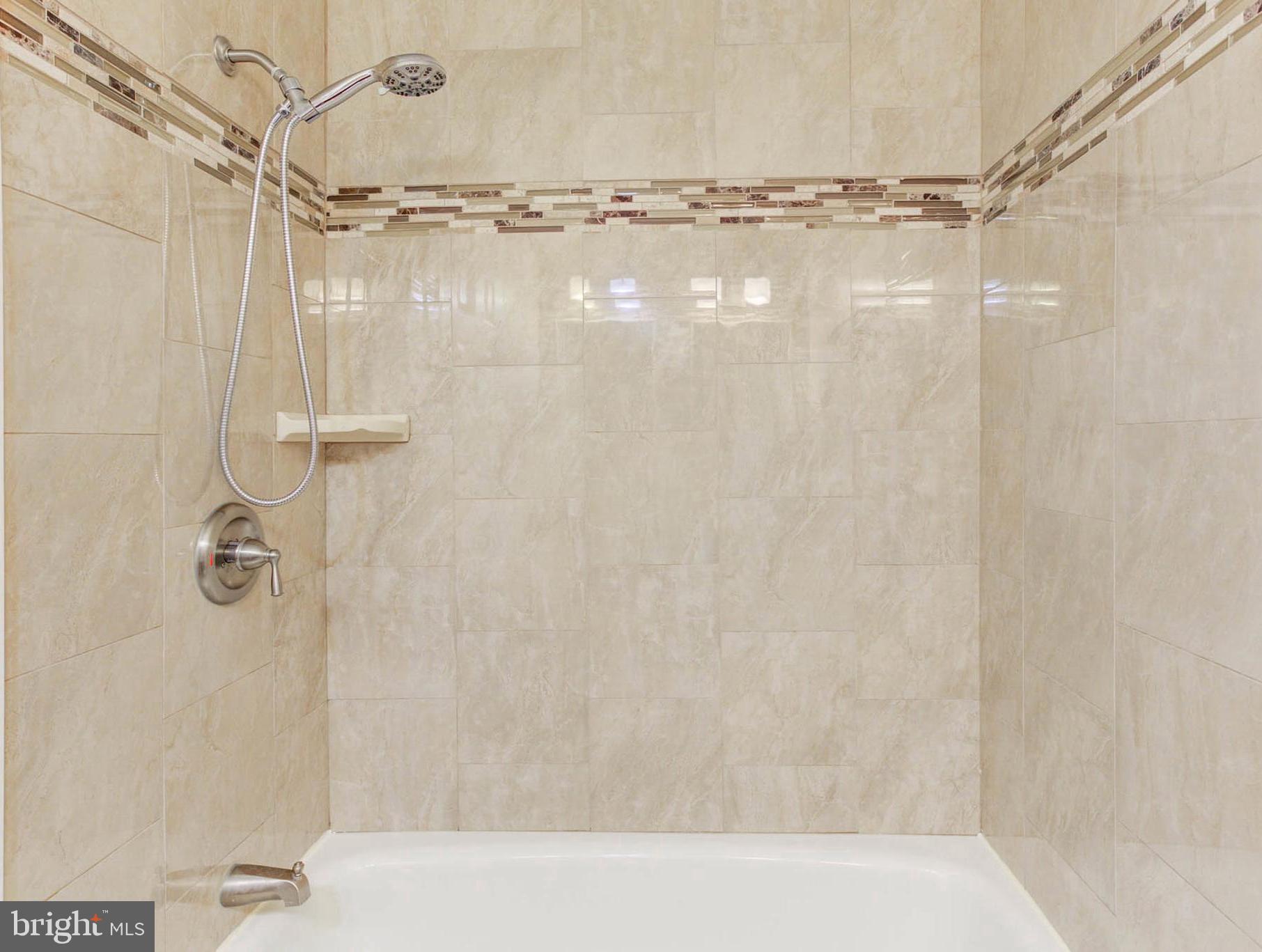 8403 Harker Drive Potomac, MD 20854 - Photo 22 of 33 a bathroom with a shower and a glass door