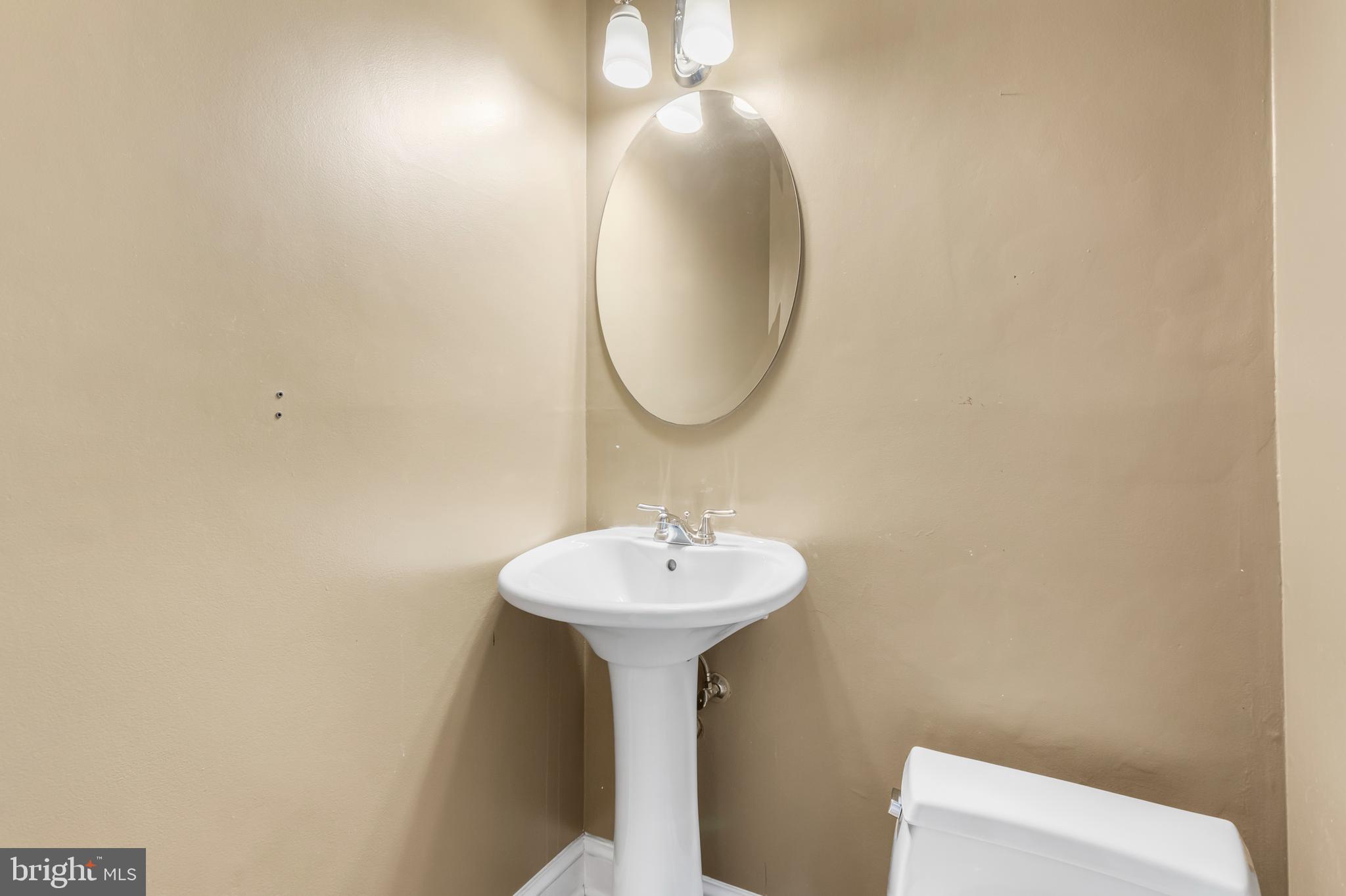 8403 Harker Drive Potomac, MD 20854 - Photo 26 of 33 a bathroom with a sink and a mirror