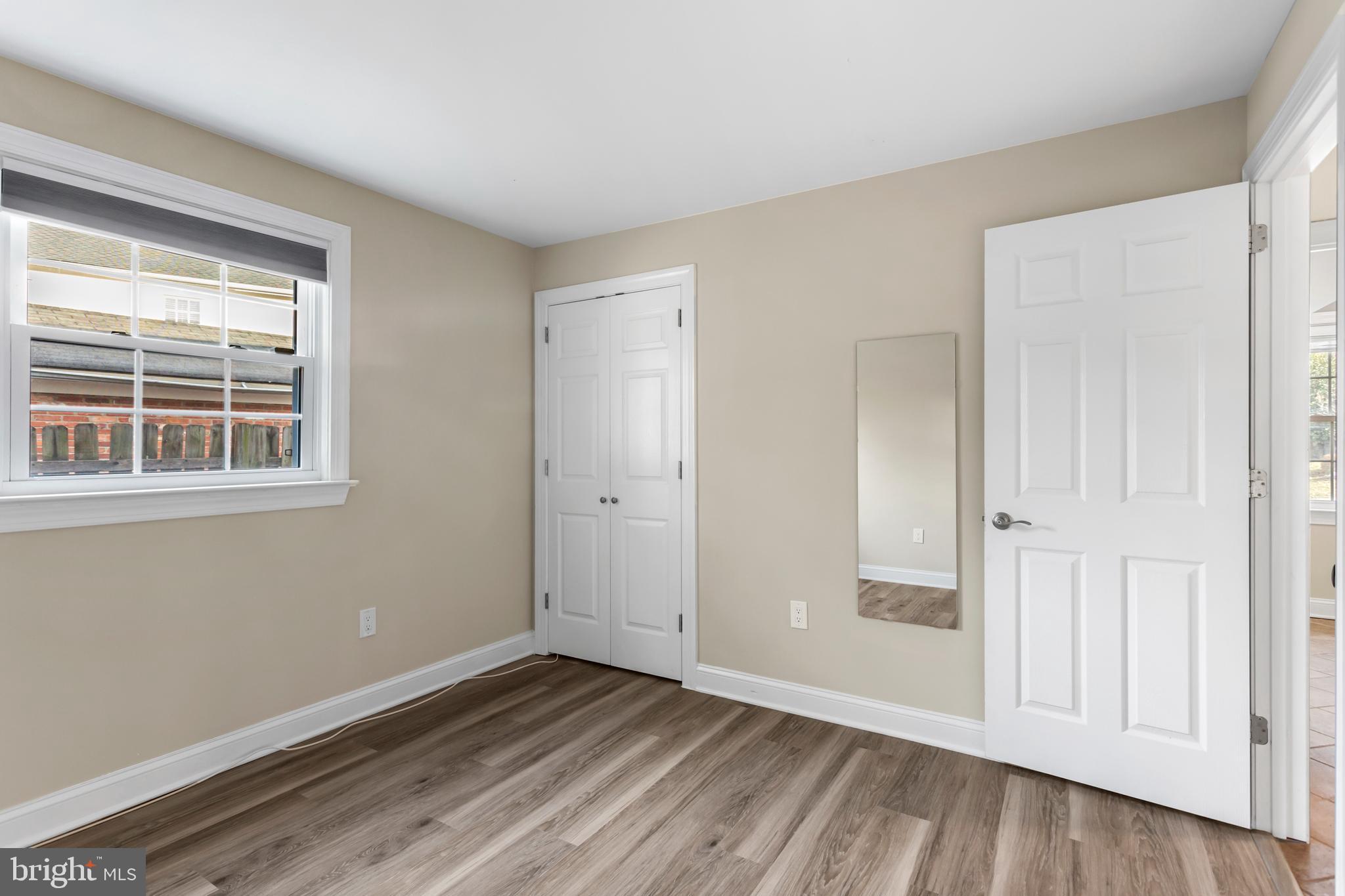 8403 Harker Drive Potomac, MD 20854 - Photo 27 of 33 a view of an empty room with wooden floor and a window
