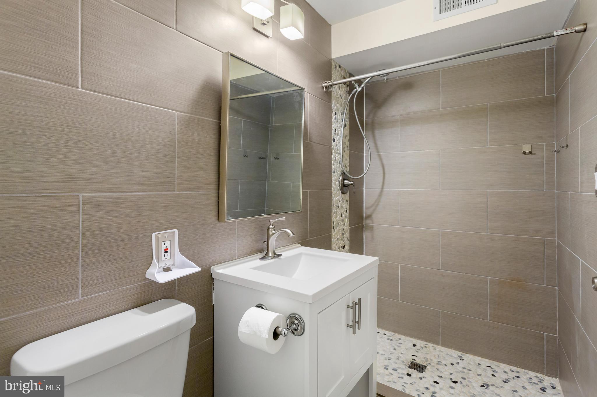 8403 Harker Drive Potomac, MD 20854 - Photo 29 of 33 a bathroom with a sink a toilet and shower