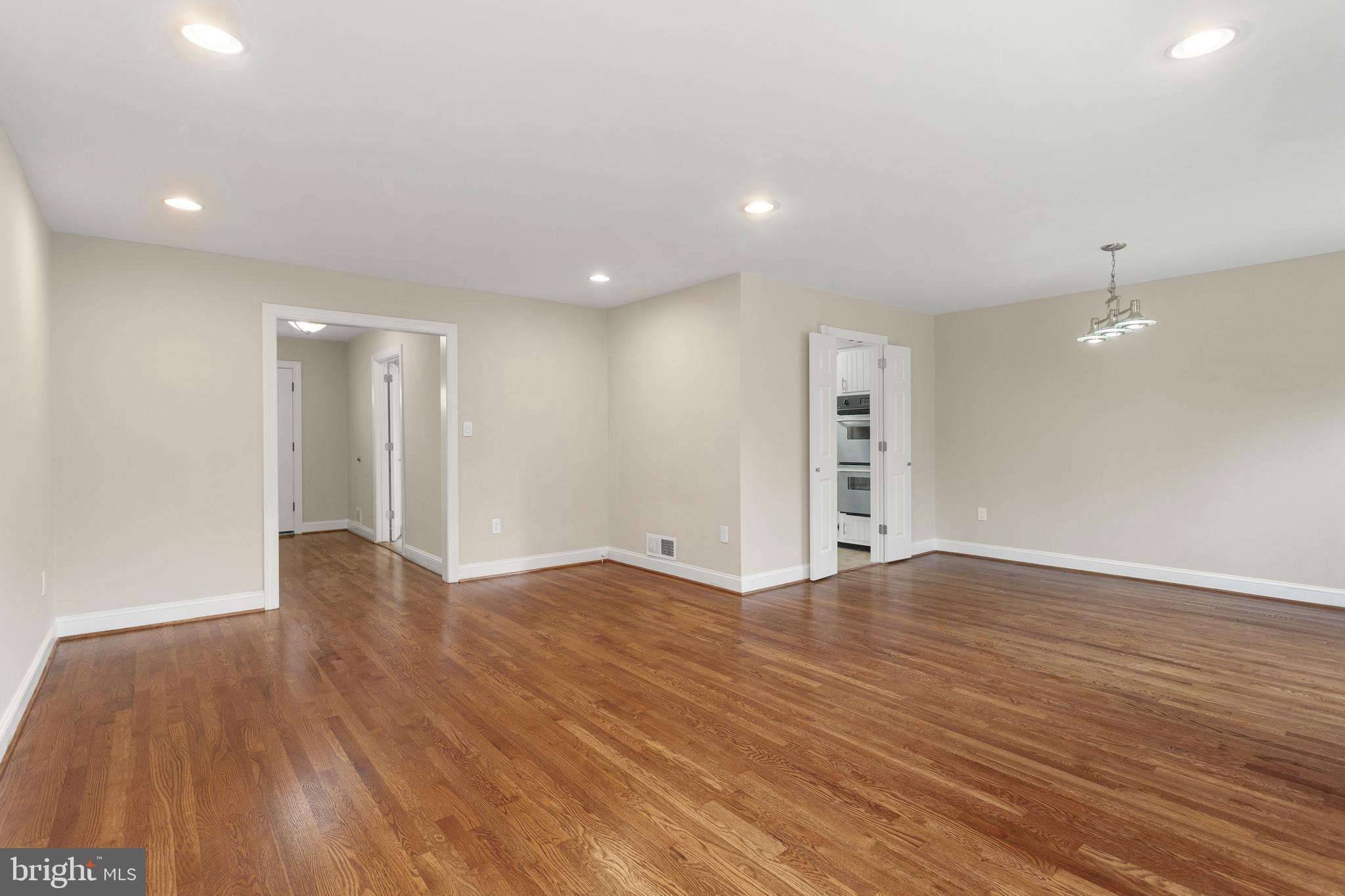8403 Harker Drive Potomac, MD 20854 - Photo 3 of 33 a view of an empty room with wooden floor and window